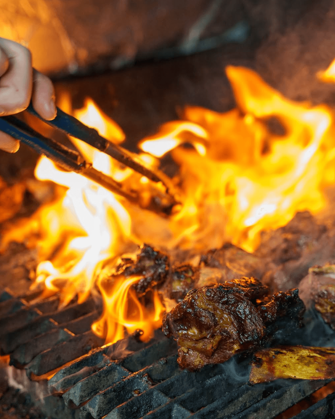 Traditional charcoal grilling of Indonesian ribs at Pondok Nasi Bakar