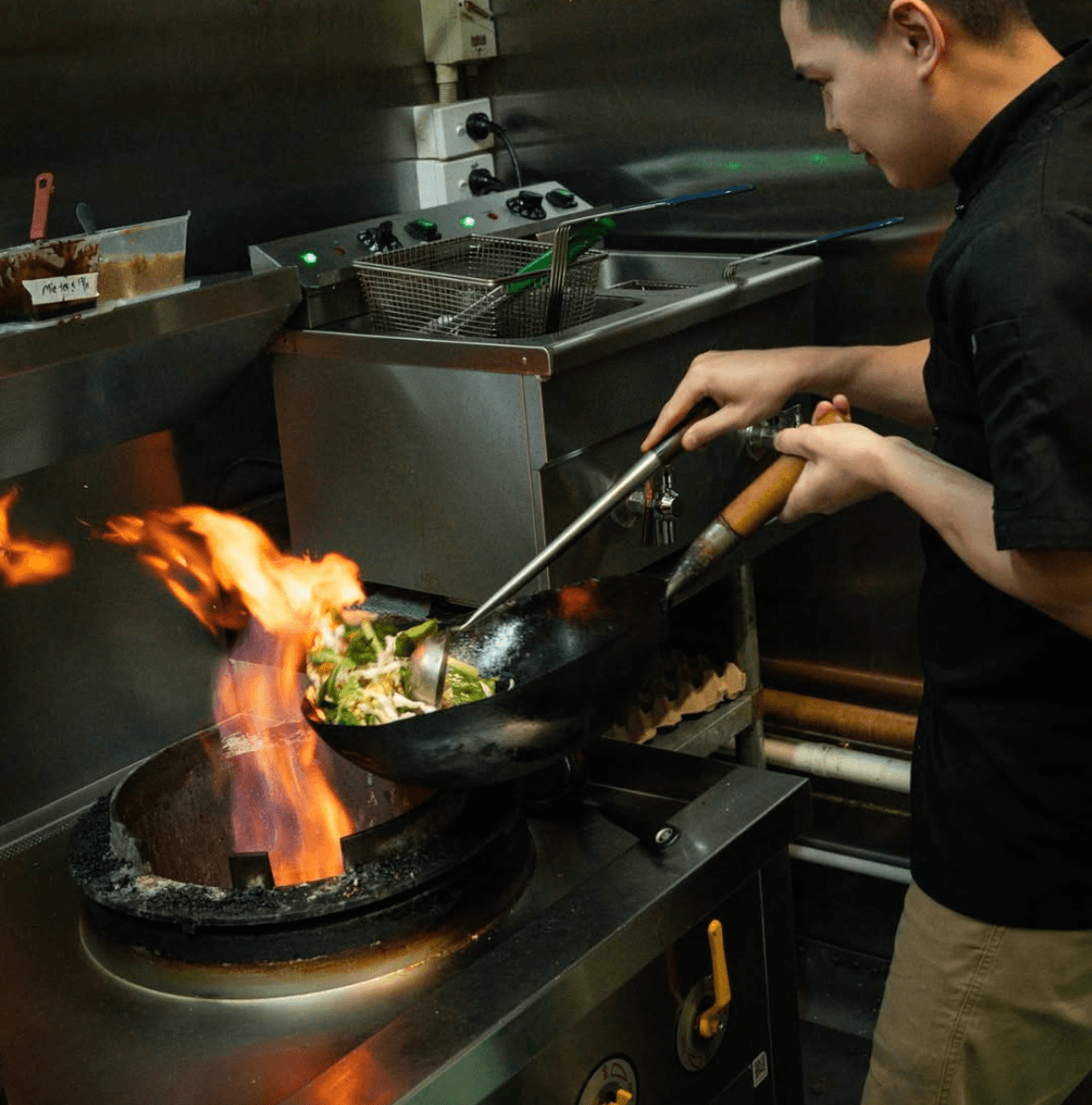 Chef cooking with fire at Pondok Nasi Bakar